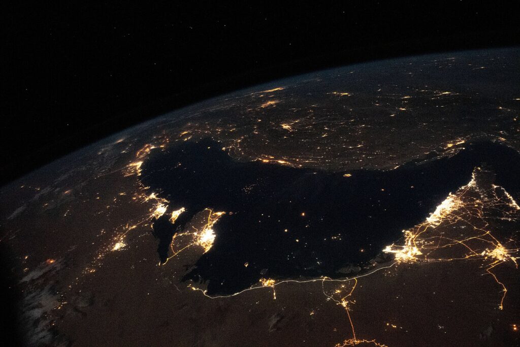 NASA astronaut photo of the Persian Gulf at night showing city lights and shipping routes near the Strait of Hormuz